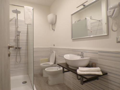 a bathroom with a sink and a toilet and a shower at Casa di Nonna Margherita in Trecase