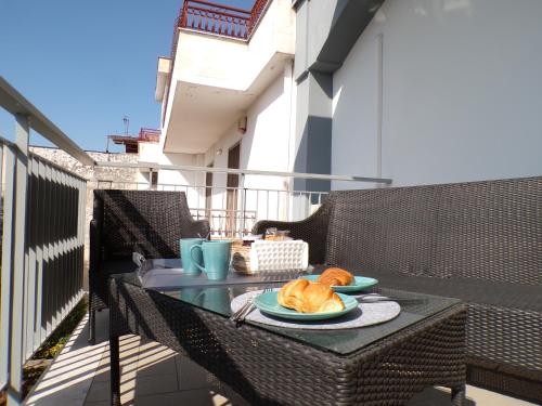 a table with a plate of food on a balcony at Casa di Nonna Margherita in Trecase