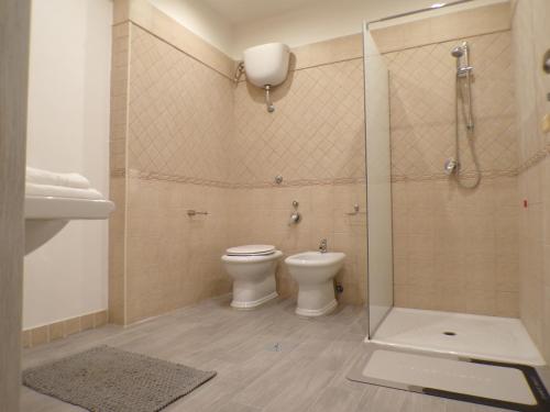 a bathroom with a toilet and a glass shower at Casa di Nonna Margherita in Trecase