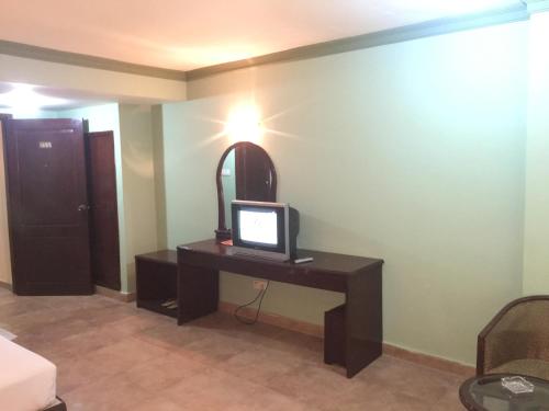 a room with a desk with a computer on it at Hotel City Inn in Chittagong