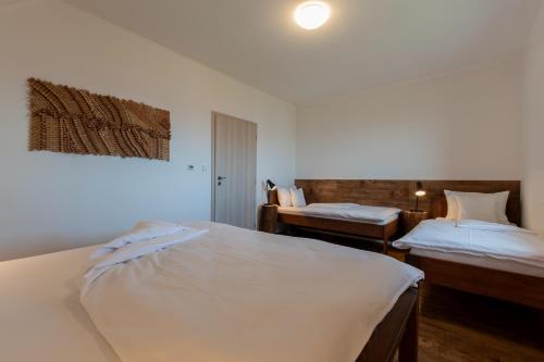 Ένα ή περισσότερα κρεβάτια σε δωμάτιο στο PALAVIA Apartments