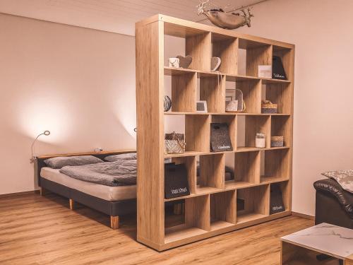 a book shelf with a bed in a room at Ferienwohnung Haßbergliebe in Ebern