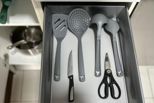 a drawer filled with utensils in a kitchen at Lujoso Loft La Moraleja in Madrid