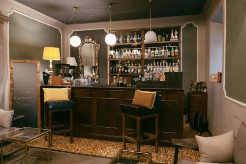 a bar at a restaurant with two stools at Quel Castello di Diegaro in Cesena