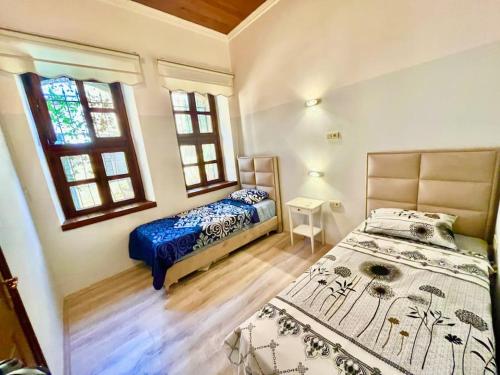 a bedroom with two beds and a window at Famous Elegant Villa in Antalya