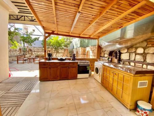 a large kitchen with a stove and a patio at Famous Elegant Villa in Antalya