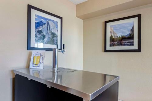 une table en verre dans une pièce avec deux photos sur le mur dans l'établissement Comfort Inn & Suites Rocklin, à Rocklin