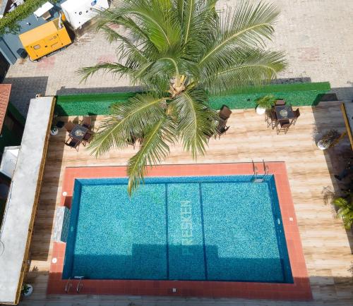 an overhead view of a swimming pool with a palm tree at Presken Hotel in Lagos