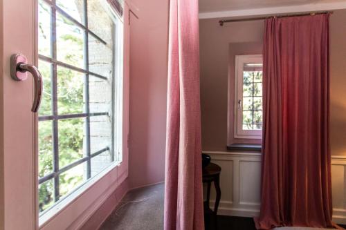 a window in a room with pink curtains at Quel Castello di Diegaro in Cesena
