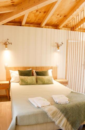 a bedroom with a large bed with two towels on it at Villa Garcia in Terras de Bouro