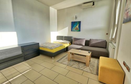 a living room with a couch and a table at Apartment Ken near Terme Paradiso in Dobova