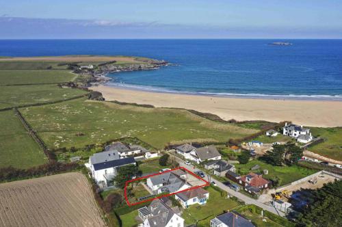 an aerial view of a house next to a beach at Beachside holiday home in Saint Merryn
