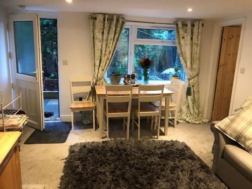 a dining room with a table and chairs and a window at The Old Post Office, Knaresborough in Knaresborough