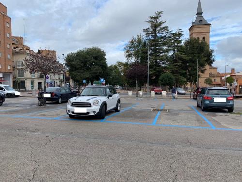 a white car is parked in a parking lot at Apartamento Turistico Dct. Creus in Guadalajara
