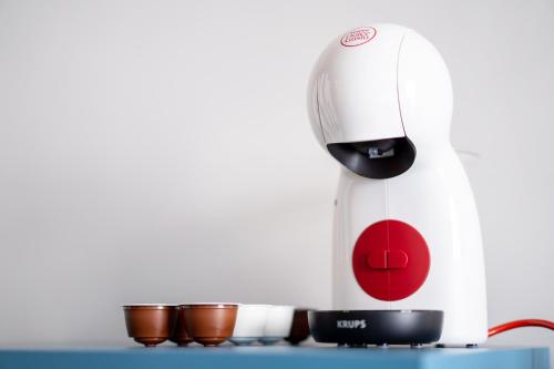 a coffee maker sitting on a counter next to cups at Mercure St. Julian's Malta in St Julian's