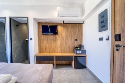 a bedroom with a desk and a shower at Island Sea Side Hotel - Adults Only in Rhodes Town
