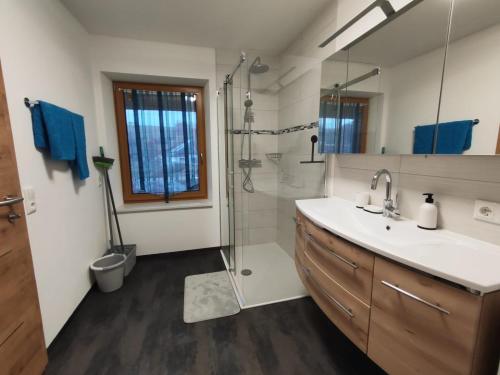 a bathroom with a sink and a shower at Martlmühle Hof in Schlüsslberg