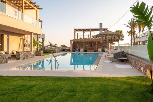 a swimming pool in the backyard of a house at High Beach White - Adults Only in Malia