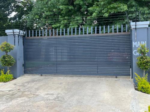 a large blue garage door in a driveway at Ubuntu Lifestyle Estate - Phalaphala DeLux in Krugersdorp