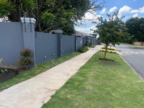 a fence on the side of a road at Ubuntu Lifestyle Estate - Phalaphala DeLux in Krugersdorp