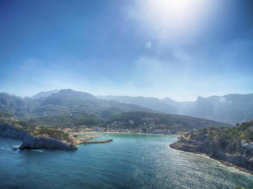 a view of a body of water with mountains at Hostal Nadal in Sóller