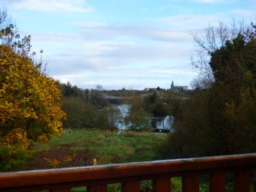 a view of a river from a balcony at Escape to the Cabin in Belturbet