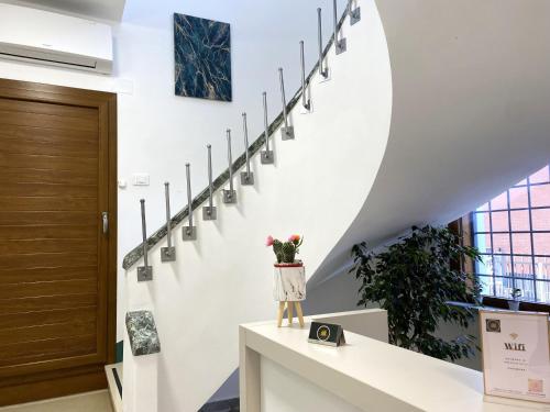 a staircase in a house with a cat statue on a counter at RobHouse in Passo Corese
