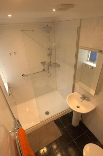 a bathroom with a shower and a sink at Family House - Breath Taking Views Over Mounts Bay in Newlyn