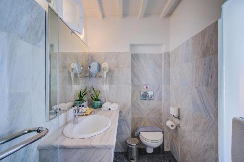 a bathroom with a sink and a toilet at Hotel Madalena in Mýkonos City