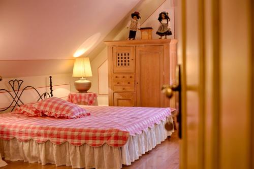 a bedroom with a bed with a dresser and a bed sidx sidx sidx sidx at Villa Rosa in Dunajská Streda