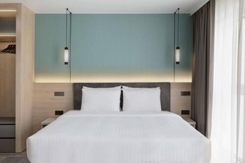 a bedroom with a large white bed with two pillows at Residence Inn by Marriott Hamburg Altona in Hamburg