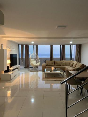 a large living room with a couch and a television at NICE DUPLEX, PRAIA in Praia