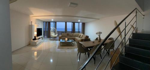 a living room with a couch and a table at NICE DUPLEX, PRAIA in Praia