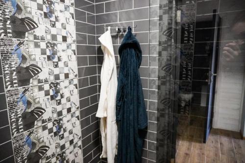 a robe hanging on a wall in a bathroom at Na Pagorbi Lutsk in Luts'k