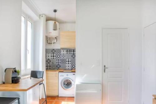 une cuisine avec un réfrigérateur et une machine à laver dans l'établissement Charmant studio proche de la timone, à Marseille