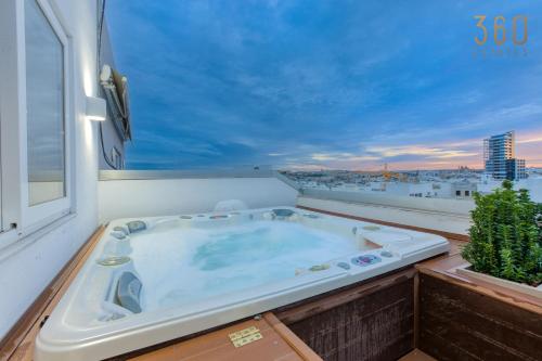 a hot tub sitting on top of a balcony at Beautiful 3BR Triplex penthouse with Hot-Tub by 360 Estates in Il-Gżira