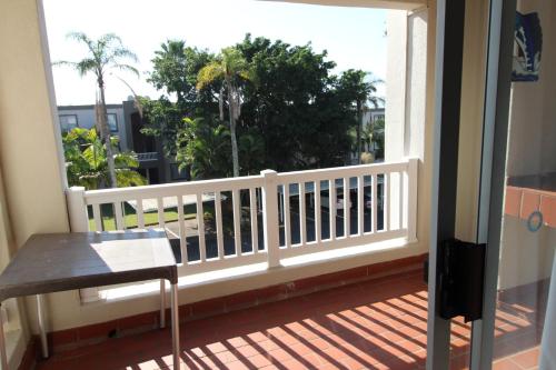 a balcony with a white railing and a table at Laguna La Crete 166 in Margate