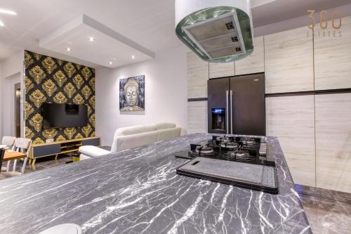 a kitchen with a counter top and a stove at Beautiful 3BR Triplex penthouse with Hot-Tub by 360 Estates in Il-Gżira