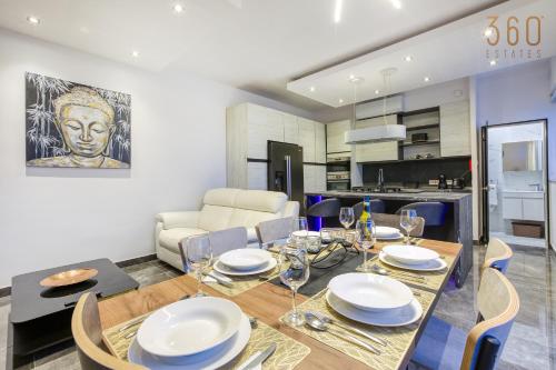 a dining room and kitchen with a table and chairs at Beautiful 3BR Triplex penthouse with Hot-Tub by 360 Estates in Il-Gżira