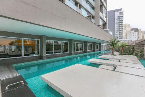 a swimming pool in the middle of a building at MARCOLINI - Flat em frente ao Allianz Parque in Sao Paulo