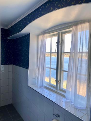 a bathroom with a window with a view of the ocean at Ericsbergs Slott in Katrineholm