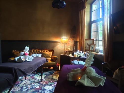 a hotel room with two beds and a window at Domaine Bohème I art de vivre in Guebwiller