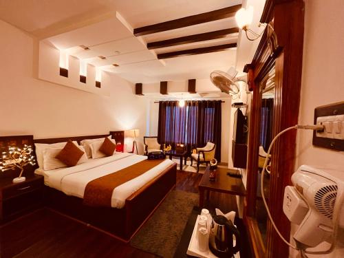 a hotel room with a bed and a desk at Hotel The North Wind in City Center, Manali in Manāli