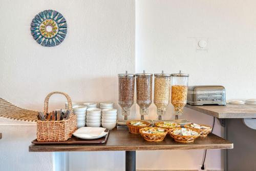 a table with glasses and baskets of food on it at Hotel Carvoeiro Plaza in Carvoeiro
