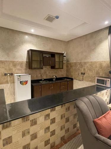 a kitchen with a counter and a refrigerator at Verona فيرونا in Riyadh