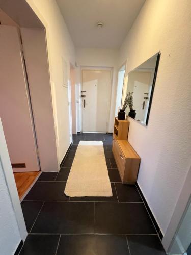 um corredor com um espelho e um tapete em Gemütliche Ferien-/Monteurenwohnung in Herne em Herne