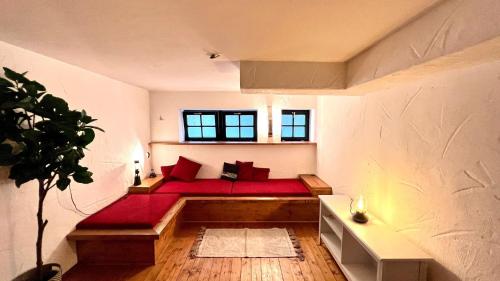 a bedroom with a bed with red pillows and a window at Designer Guest House in Cologne