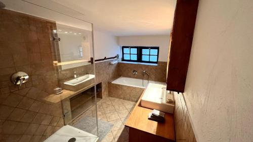 a bathroom with a shower and a sink and a tub at Designer Guest House in Cologne