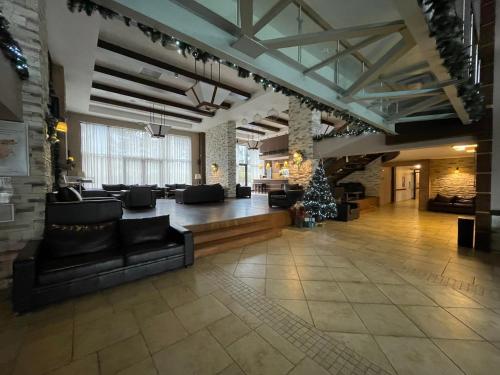 a large living room with couches and a christmas tree at Terra SP apartments-Razlog in Razlog
