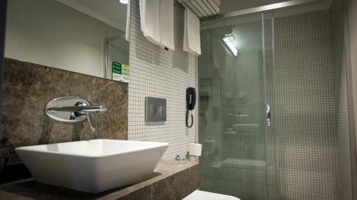 a bathroom with a sink and a glass shower at Kervansaray Bursa City Hotel in Bursa
